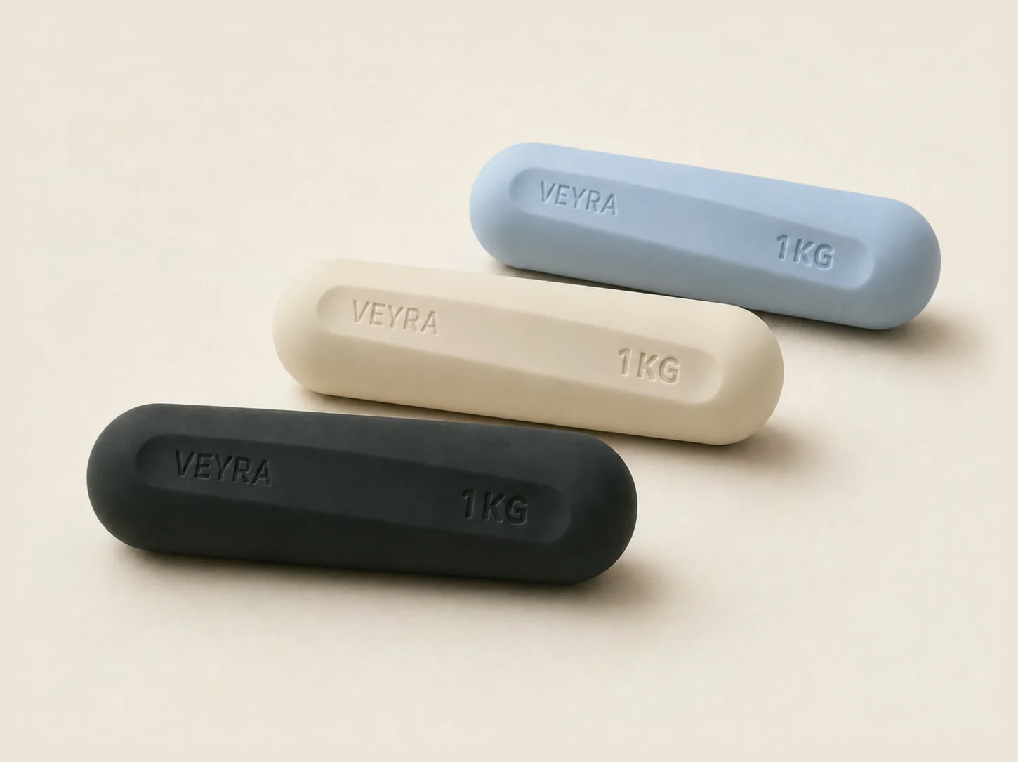 The VEYRA Weights in powder blue, cream and charcoal with debossed branding